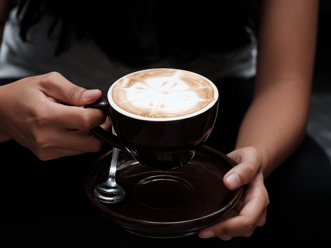 Flat white coffee in black cup